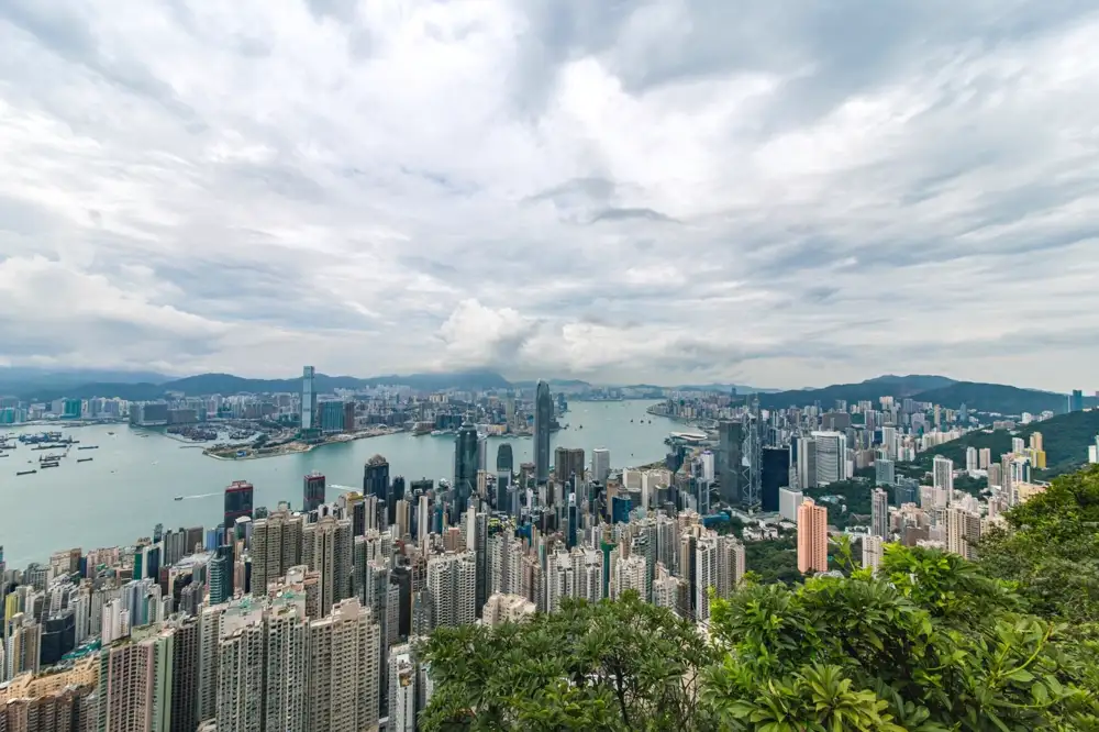 The Hong Kong Island skyline seen across Victoria Harbour from the Kowloon promenade at night