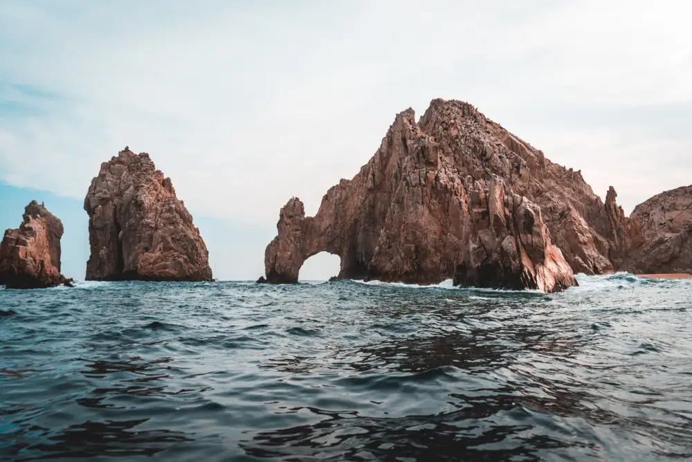 A protected horseshoe bay in Los Cabos with calm water and rock headlands at each end
