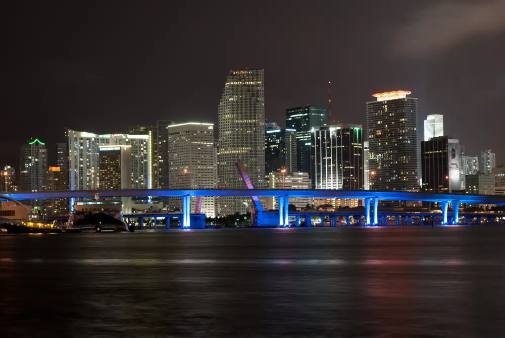 Art deco hotels along Miami Beach with the ocean and loungers in the foreground